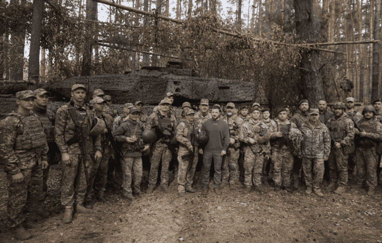 Ukrainian-President-Volodymyr-Zelenskyy-center-poses-for-photo-with-the-Ukrainian-soldiers-in-front-of-a-Leopard-2-tank-on-the-front-line-in-the-Kharkiv-region-Ukraine-Tuesday-Oct.-3-2023